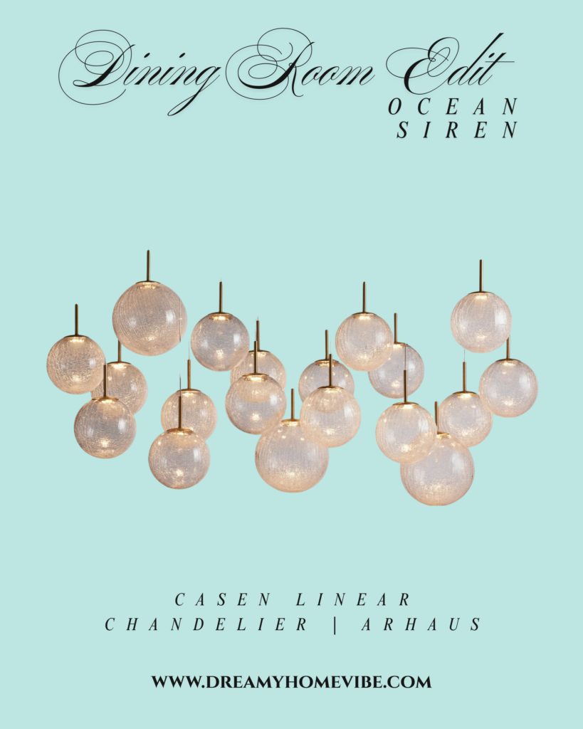Casen Linear Chandelier from Arhaus. An arrangement of 19 frosted white globe lights suspended from gold and clear attachments. Spheres are hanging at different heights and horizontal alignments, like bubbles.